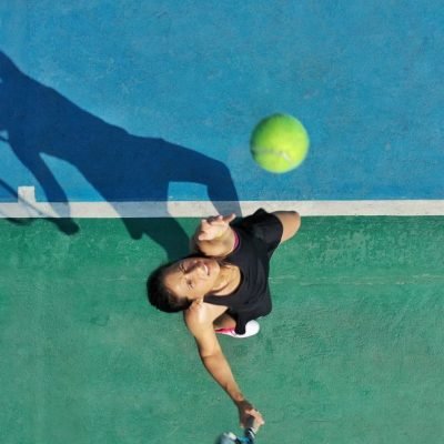 a-young-adult-woman-tennis-player-throws-ball-into-air-for-serve-casting-a-shadow-on-court-.jpg a-young-adult-woman-tennis-player-throws-ball-into-air-for-serve-casting-a-shadow-on-court-.jpg